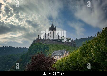 Castle Reichsburg sits above the medieval town of Cochem on the Mosel River, Germany. Stock Photo