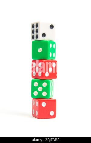 game dice of white red and green stand on each other on a white background isolate, side view Stock Photo