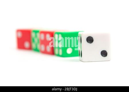 game dice of white red and green color on a white background isolate, side view Stock Photo
