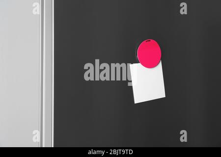Blank paper with magnet on refrigerator door Stock Photo