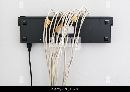 Old switching hub with the many lan cable for connection to the center server in the office building. Stock Photo