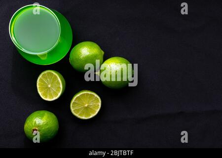 Tarragon lemonade, lime slice on a black background. the view from the top, place for text, Copy space. Stock Photo