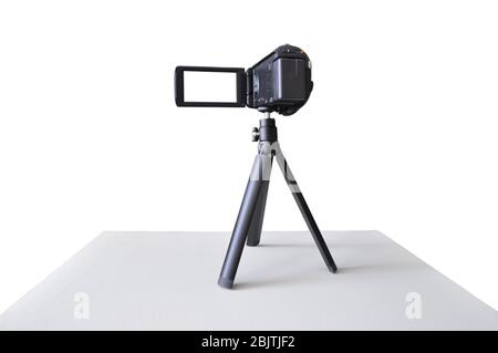 Digital video camera on a tripod isolated on white. Stock Photo