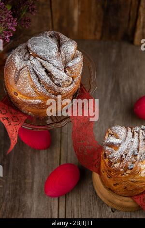 Easter cake kraffin. Kraffins with raisins, candied fruits and poppy seeds, sprinkled with powdered sugar. Close-up of homemade cake. Cruffin. Stock Photo