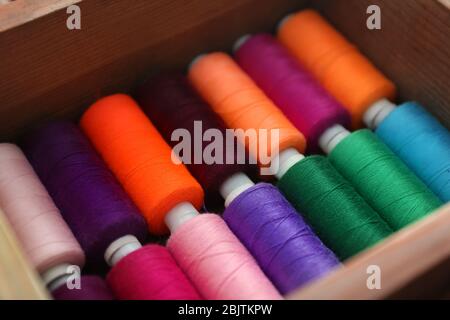 Set of color sewing threads in wooden box Stock Photo