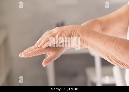 Hands of senior woman with healthy skin softened by cream with moisturizing effect Stock Photo