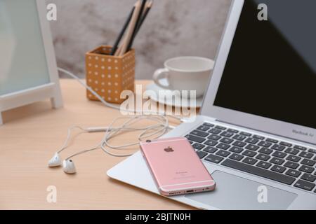 KYIV, UKRAINE - NOVEMBER 28, 2017: iPhone 6s Plus Rose Gold, earpods and MacBook Air on table Stock Photo