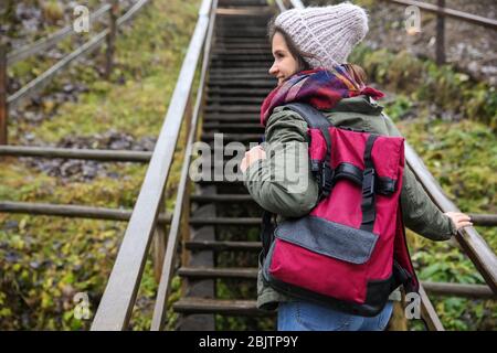 Female tourist walking up the steps in countryside Stock Photo