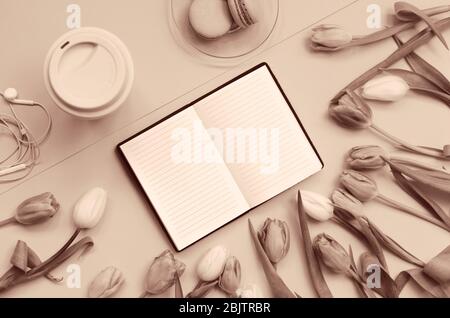 Notepad with wish list for future plans. flat lay composition with flowers, notepad, a cup of coffee and sweets. monochrome Stock Photo
