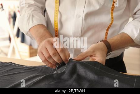 Young tailor working in atelier Stock Photo