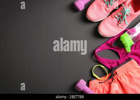 Gym stuff and blank space for exercise plan on black background. Flat lay composition Stock Photo