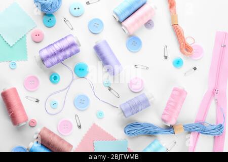 Composition with sewing threads and accessories on white background, top view Stock Photo