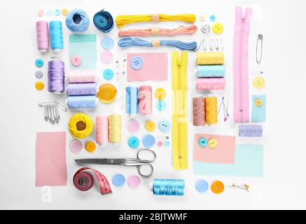 Composition with sewing threads and accessories on white background, top view Stock Photo