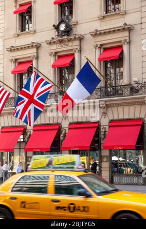 Taxi drives by Cartier Boutique on 5th Avenue in Manhattan, New York City, USA Stock Photo