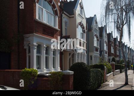 Colourful Victorian Terraced Housing Row Houses Yellow Red Brick Classical Traditional Street Pattern on Airedale Avenue, Chiswick, London W4 Stock Photo