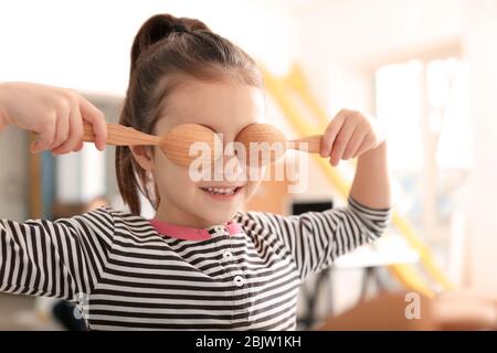 Cute little girl having fun in kitchen Stock Photo