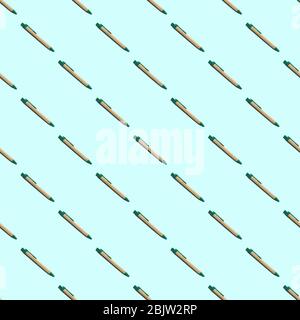 Seamless pattern of causal ballpoint pens on a blue background. Close up. Stock Photo