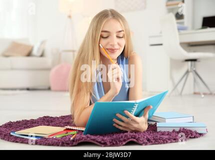 Female student preparing for exam indoors Stock Photo