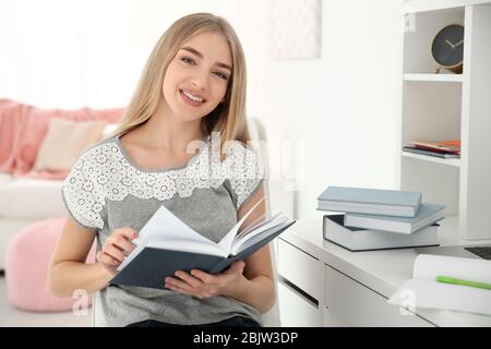 Female student preparing for exam indoors Stock Photo