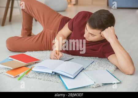 Male student preparing for exam indoors Stock Photo