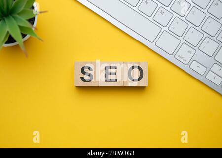 Modern marketing buzzword SEO - Search engine optimisation. Top view on wooden table with blocks. Top view. Close up. Stock Photo