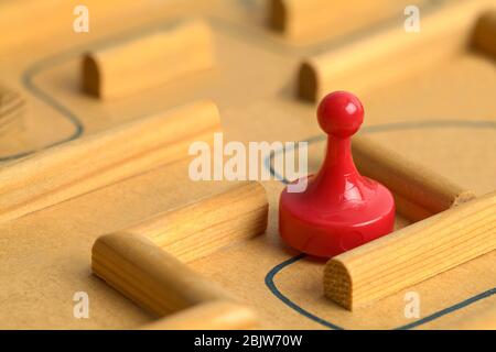 Red Game Piece on Path in Wooden Maze. Stock Photo