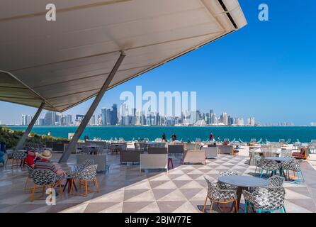 Doha. The MIA Park Cafe in MIA Park with the skyline of the West Bay Central Business District behind, Doha, Qatar, Middle East Stock Photo