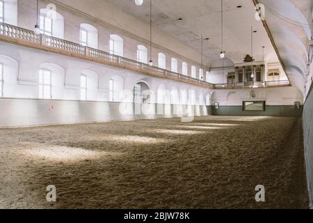 Royal manege with sand for horses in Denmark Copenhagen in territory Christiansborg Slot. Riding hall with sandy covering. Indoor riding facility at Stock Photo
