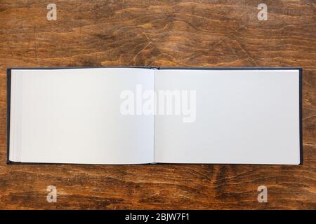 Blank open notebook mockup, Empty paper diary, branding template on wooden desk background, copy space, top view Stock Photo