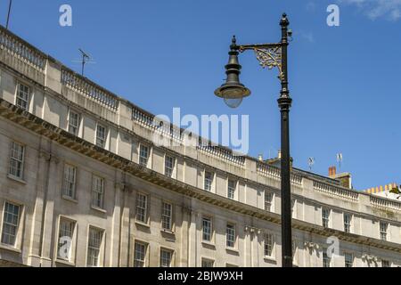 LONDON, ENGLAND - JULY 2018:  Exterior view of apartments in central London with a vintage design street light in the foreground. Stock Photo