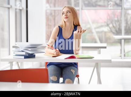 Student preparing for exam in classroom Stock Photo
