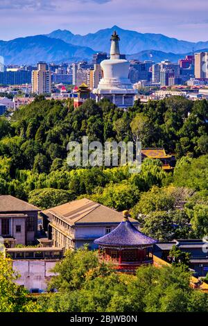 Beijing / China - October 8, 2018: White Pagoda and west Beijing, with the Western Hills (Xishan) in the distance. View from Jingshan park hill. Stock Photo