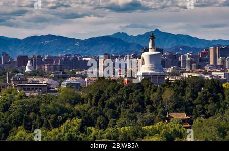 Beijing / China - October 8, 2018: White Pagoda and west Beijing, with the Western Hills (Xishan) in the distance. View from Jingshan park hill. Stock Photo