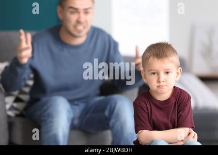 Father scolding his little son at home Stock Photo