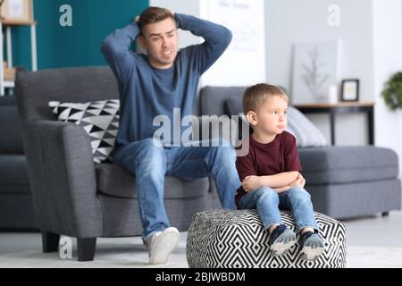 Father scolding his little son at home Stock Photo