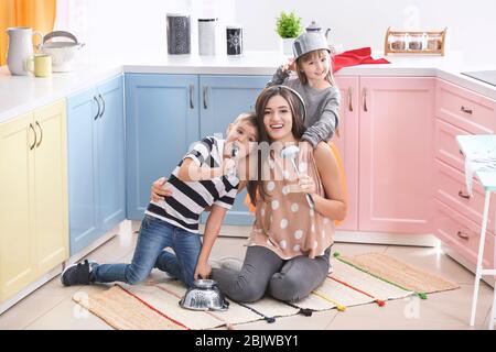 Happy family playing with kitchenware at home Stock Photo