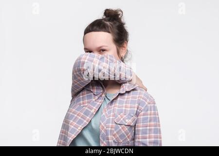 Caucasian woman covers his face with his hands. Depression and loneliness in youth. Stock Photo