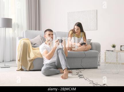 Emotional couple playing video game at home Stock Photo