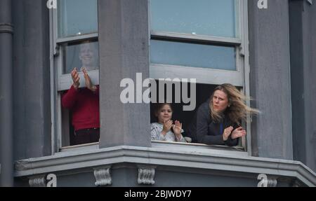 Brighton UK 30th April 2020 - Residents in Kemp Town Brighton take part in the  Clap For Our Carers as they applaud NHS staff and key workers on a windy evening as the country thanks them for their efforts in the battle against coronavirus COVID-19   : Credit Simon Dack / Alamy Live News Stock Photo
