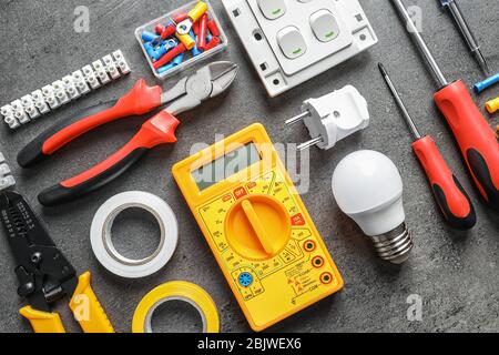 Different electrical tools on grey background Stock Photo