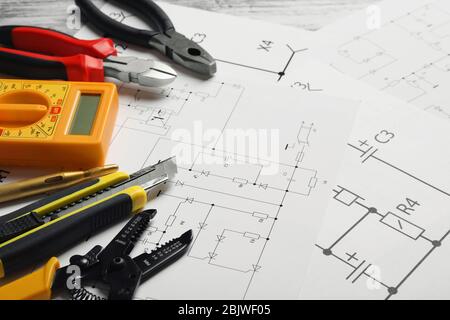 Different electrical tools on circuit diagram Stock Photo