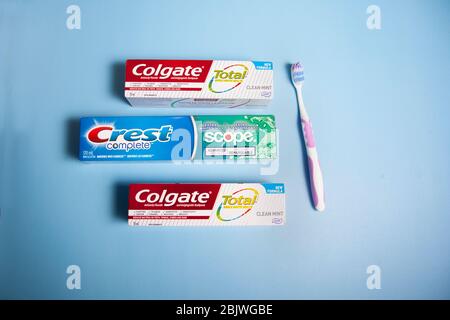Halifax, Canada- April 11, 2020- Colgate and Crest brand toothpaste and a toothbrush Stock Photo