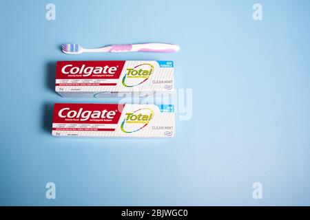 Halifax, Canada - April 11, 2020- two packages of Colgate brand toothpaste with a toothbrush on a blue background Stock Photo