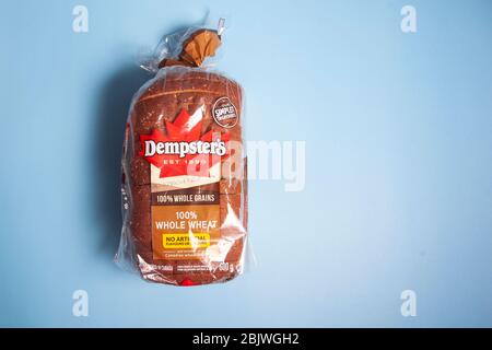 Halifax, Canada - April 11, 2020: A loaf of Dempsters brand whole wheat bread on a blue background Stock Photo