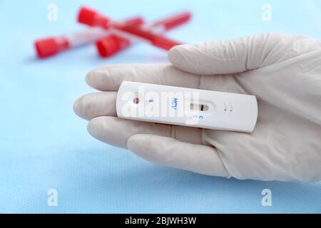 Doctor holding express test for HCV on blurred background Stock Photo