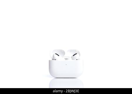 Technologies, electronics. White modern wireless earphones in case isolated on white background Stock Photo