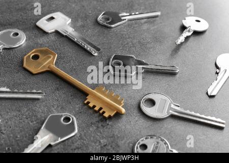 Keys and one different on grey background Stock Photo
