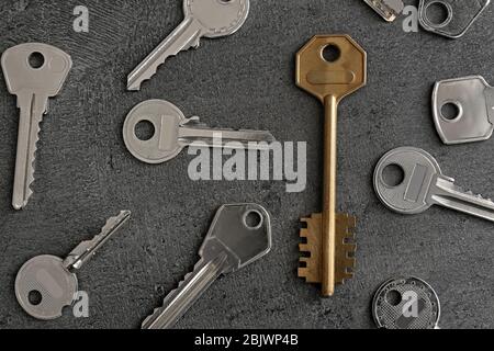 Keys and one different on grey background Stock Photo