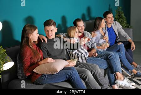 Young people watching movie in home cinema at night Stock Photo