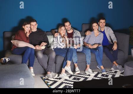 Young people watching movie in home cinema at night Stock Photo